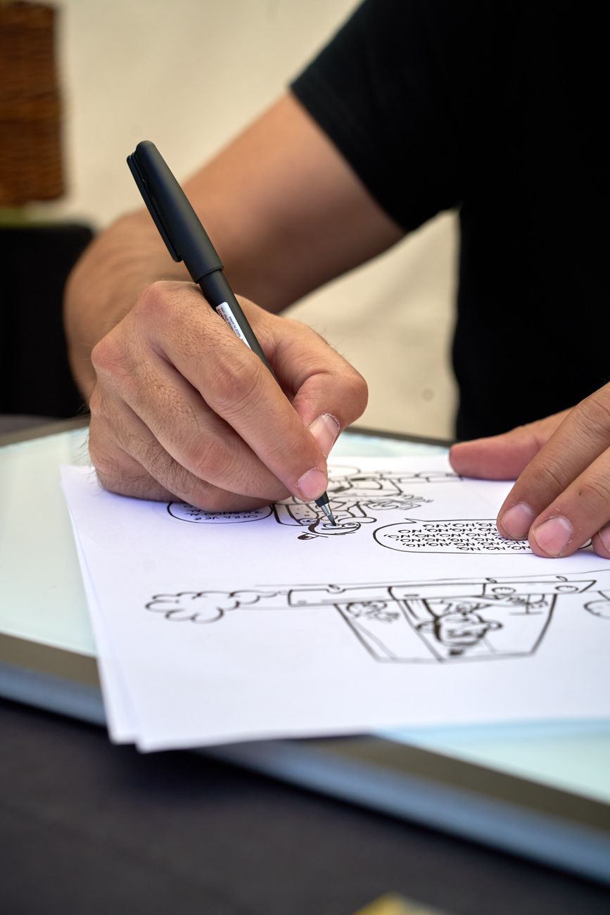 Close-up of an illustrator sketching a cartoon in Tudela de Duero, Spain.