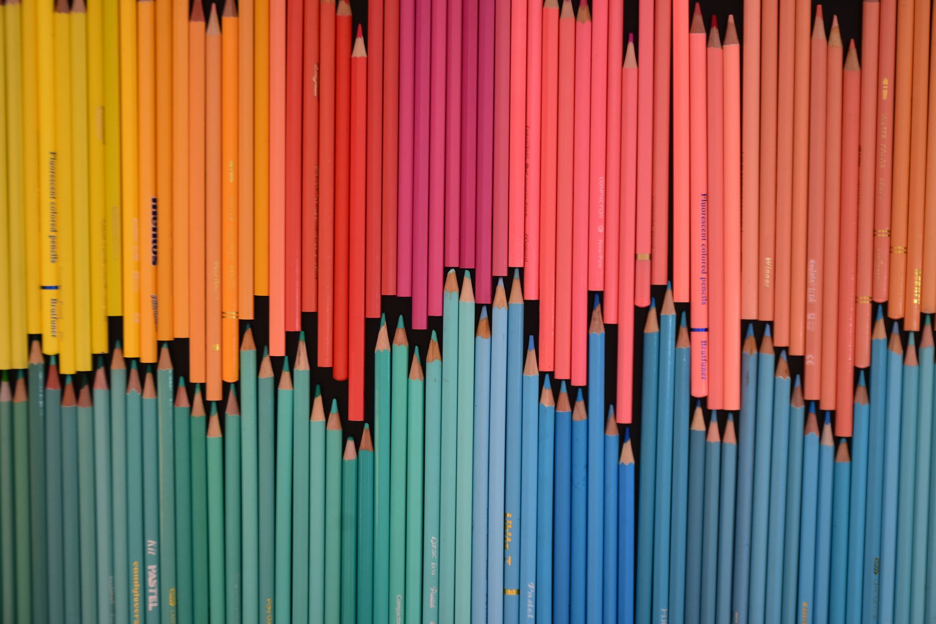 A vibrant array of colored pencils neatly arranged in a gradient. Perfect for creative and educational themes.