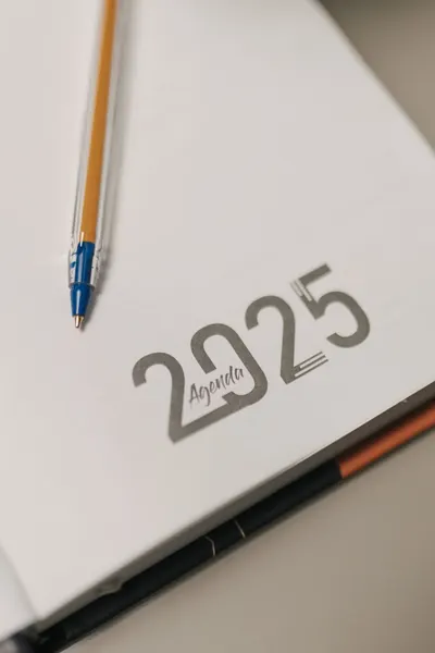 Close-up of a 2025 agenda with a pen, perfect for planning and organization.