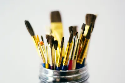 A diverse set of paintbrushes displayed in a jar, perfect for arts and crafts enthusiasts.