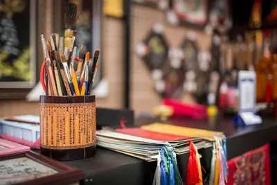 Traditional Vietnamese calligraphy tools set against a colorful backdrop at a crafts stall in Ho Chi Minh City.