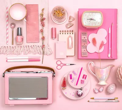 A stylish flat lay of pink stationery and decor, perfect for a feminine aesthetic.