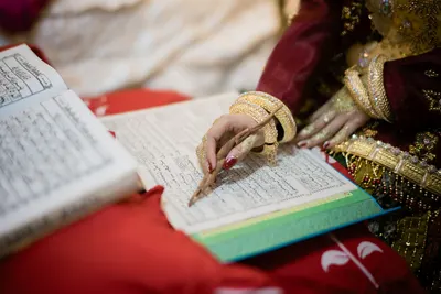 Intricate traditional attire and script in a wedding ceremony in Indonesia.