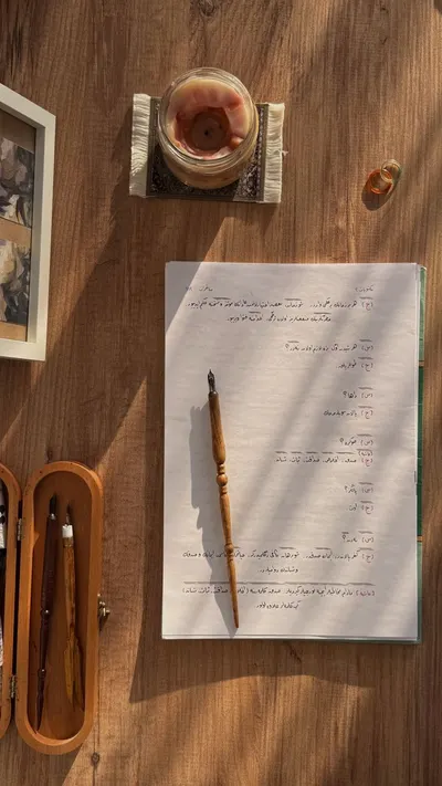 Warm and inviting flat lay of a wooden desk setup with a pen and notebook, ideal for study inspiration.
