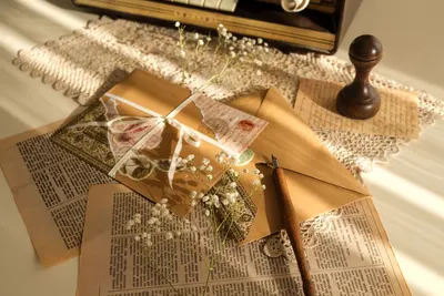A cozy vintage setup with letters and stationery on lace, perfect for nostalgia lovers.
