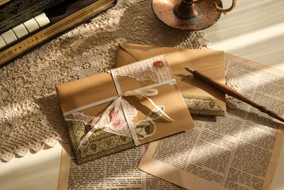 Charming vintage letters and envelopes on lace with a quill pen, creating a nostalgic atmosphere.
