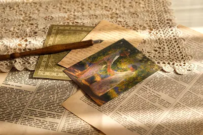 Still life of vintage letters, documents, and a fountain pen on a crochet backdrop.