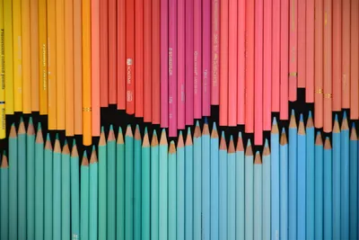 A colorful arrangement of sharpened colored pencils, showcasing a gradient effect.