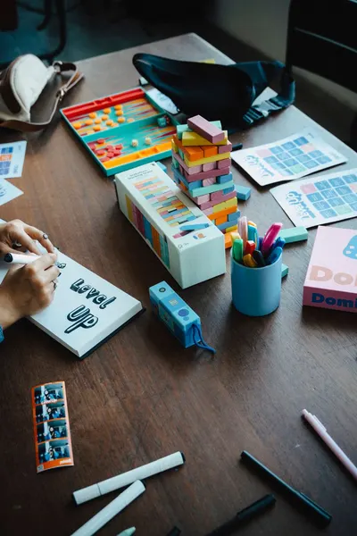 Colorful and organized workspace with games, stationery, and playful elements for creativity.