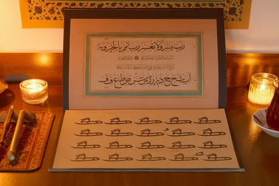 An arrangement of Arabic calligraphy with candles, evoking a warm, cultural ambiance.
