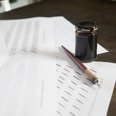 Calligraphy practice setup with ink pen and sheets, perfect for learning calligraphy techniques.