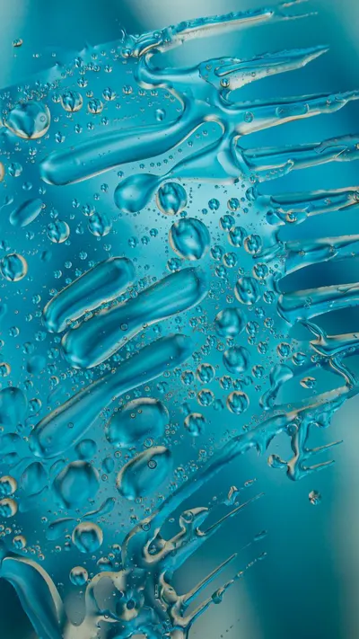Abstract close-up of blue water bubbles and streaks, creating a mesmerizing pattern.