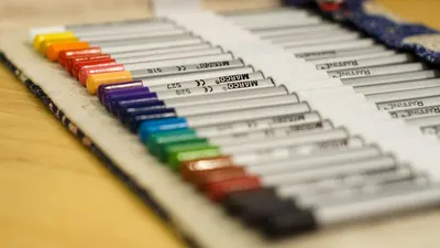 A close-up of neatly arranged colored drawing pens, perfect for artists.