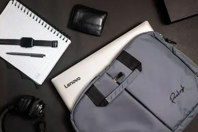 Top view of modern office essentials including a laptop, notebook, and accessories.