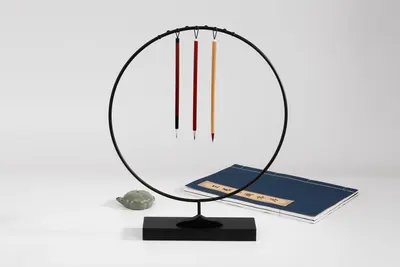 A minimalist composition showcasing traditional Japanese calligraphy brushes and writing materials.