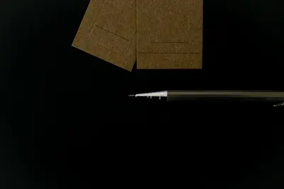 Elegant composition of business cards and a mechanical pencil on a black background.